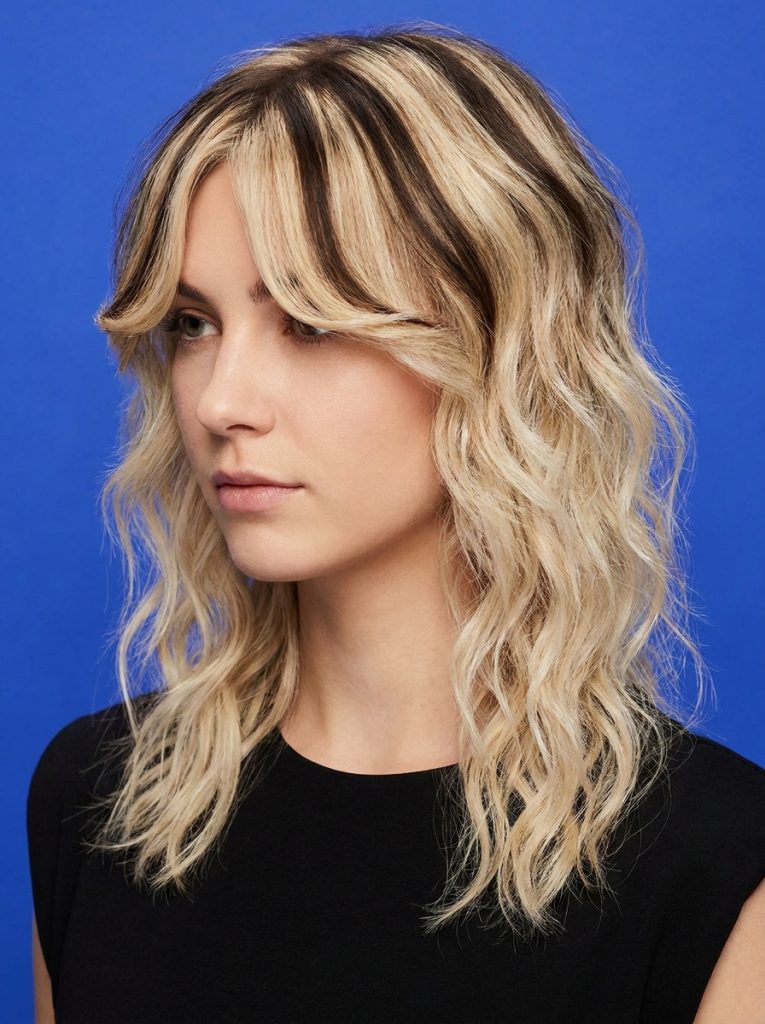 Blonde Wavy Wolf Cut With Sectioned Bangs and Crown Highlights