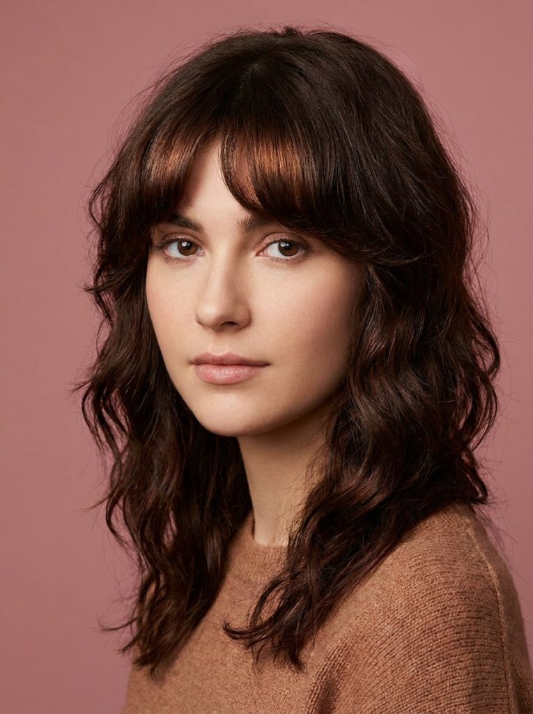 Brunette Wavy Wolf Cut With Bottleneck Bangs